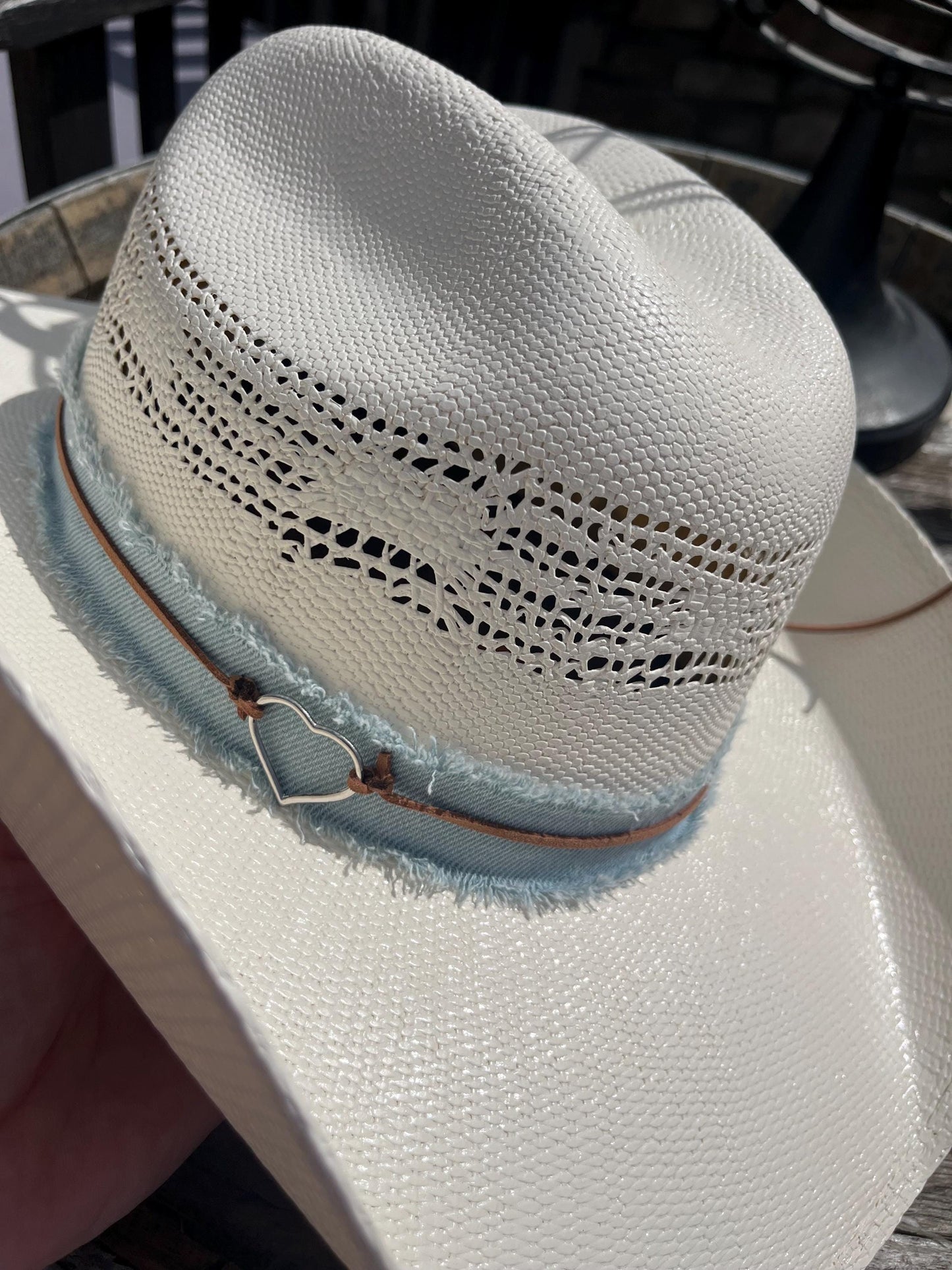 western cowboy hard straw hat with a light blue denim band.